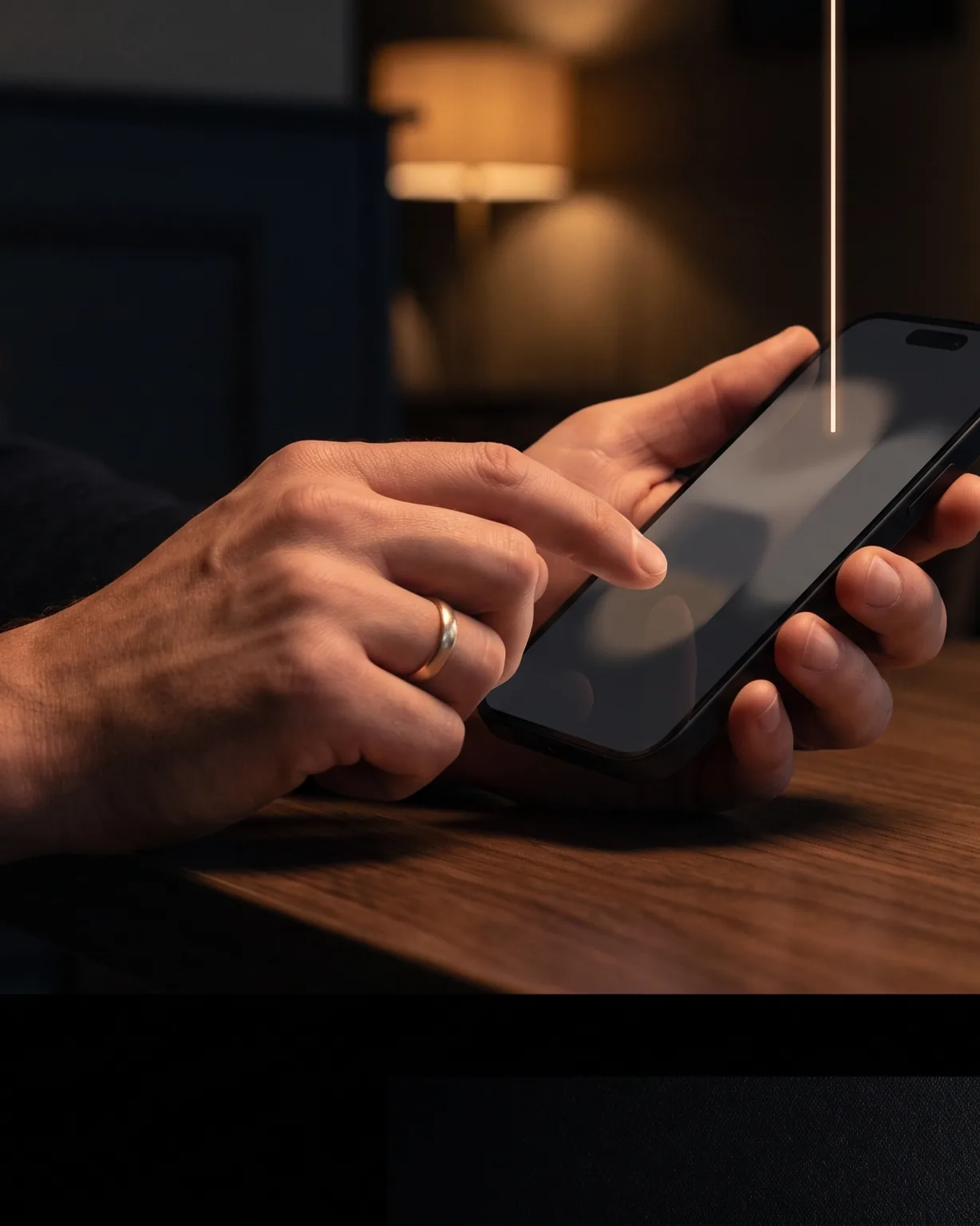 A customer types on a phone at a café table